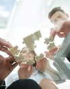 Bottom view. business team folding puzzle pieces. . Royalty Free Stock Photo