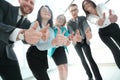 Bottom view.business team looking at the camera and showing their thumbs up. Royalty Free Stock Photo