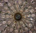 Bottom view at center of crystal chandelier lamp hang on white ceiling. Royalty Free Stock Photo