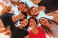 Bottom view of circle group of Caucasian happy smiling women wearing sports clothes looking in camera. Concept of sport