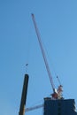 Crane on underconstruction site condomenium in building concept