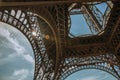 Bottom view of Eiffel Tower made in iron and Art Nouveau style, with sunny blue sky in Paris. Royalty Free Stock Photo