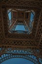 Bottom view of Eiffel Tower made in iron and Art Nouveau style, with sunny blue sky in Paris. Royalty Free Stock Photo