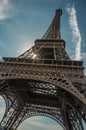 Bottom view of Eiffel Tower made in iron and Art Nouveau style, with sunny blue sky in Paris. Royalty Free Stock Photo