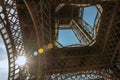 Bottom view of Eiffel Tower made in iron and Art Nouveau style, with sunny blue sky in Paris. Royalty Free Stock Photo