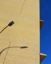 Empty building facade with geometric pattern. Blue sky and street lamp. Valencia Spain