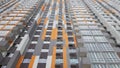 Bottom view of the facade of a new multi-storey residential building with balconies and gray and orange windows Royalty Free Stock Photo