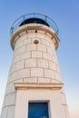 Bottom view of the Genoese lighthouse with a blue roof, from the pier