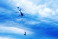 Bottom view of helicopter with cargo flying in the dramatic sky Royalty Free Stock Photo