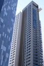 Bottom view of high-rise buildings in a big city against a blue sky. Royalty Free Stock Photo