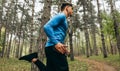 Bottom view image of young athelte man running outdoor in the morning in the forest background. Fitness male exercising in the Royalty Free Stock Photo