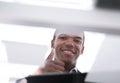 Bottom view. image of young businessman showing thumb up. Royalty Free Stock Photo