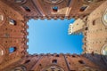 Bottom view of the interior of a historic building in Siena with detail of the bell tower