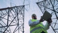 Bottom view of a male engineer operating a tablet between ETL constructions