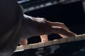 Bottom view of male hands touching black and white piano keys. Musician plays a melody with his fingers on a musical Royalty Free Stock Photo