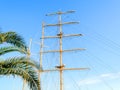 Bottom view of the mast, sail yards with the lowered sails and rigging of a sailing ship against a blue sky Royalty Free Stock Photo