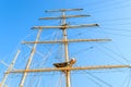 Bottom view of the mast, sail yards with the lowered sails and rigging of a sailing ship against a clear sky Royalty Free Stock Photo