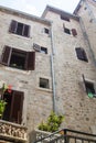 bottom view of a medieval stone house with Windows and wooden sh Royalty Free Stock Photo