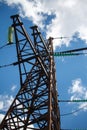 Bottom view of a metal pole of a power line with a multitude of electrical wires against a blue cloudy sky Royalty Free Stock Photo