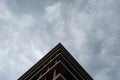 Bottom view of modern building in business district against overcast sky