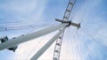 Bottom view of modern Ferris wheel on blue sky background. Action. Ferris wheel doesn`t work on clear day. Many lines Royalty Free Stock Photo