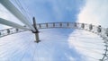 Bottom view of modern Ferris wheel on blue sky background. Action. Ferris wheel doesn`t work on clear day. Many lines Royalty Free Stock Photo