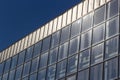 Bottom view of a modern skyscraper building with glass window against sky background for promotional content. Contemporary Royalty Free Stock Photo