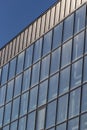 Bottom view of a modern skyscraper building with glass window against sky background for promotional content. Contemporary Royalty Free Stock Photo