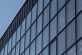 Bottom view of a modern skyscraper building with glass window against sky background for promotional content. Contemporary Royalty Free Stock Photo