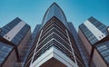 Bottom view of modern skyscrapers in business district against blue sky. Looking up at business buildings in downtown Royalty Free Stock Photo