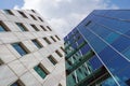 Bottom view through a modern tall skyscraper up to the blue clouds sky. Abstract fragment of architecture Royalty Free Stock Photo