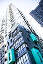 bottom view of a multi-storey modern aqua colored building. urban jungle