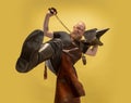 Bottom view of muscular bearded bald man, blacksmith in leather apron or uniform isolated on yellow studio background