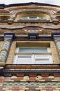 Bottom view window of old, historical building. Front of structure, edifice with classical mosaic architecture style