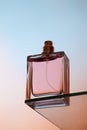 Bottom view of one spray bottle of perfume stands on a glass table Royalty Free Stock Photo