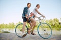 Bottom view portrait of young couple, woman and her boyfriend going for bike ride in river enbankment on summer day Royalty Free Stock Photo