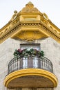 Bottom view of round wood and metal balcony and ornate golden cornice Royalty Free Stock Photo