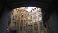 Bottom view of rounded house on background of sky. Action. Old architecture of closed courtyards of St. Petersburg seems