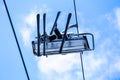 Bottom view of skiers have a fun on chair lift