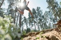 Bottom view of sportsman jump over hole in forest