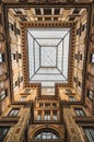 Bottom view of a square-shaped glass dome inside a Roman courtyard