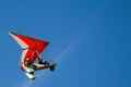 Bottom view super lightweight hang glider or trike flies in clear blue sky