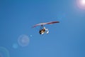 Bottom view super lightweight hang glider or trike flies in clear blue sky