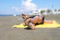 Bottom view on the teen boy feet in the sand lying on yellow towel and sunbathes on the beach. Royalty Free Stock Photo