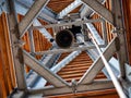 Bottom view to bell inside of bell tower. Riveted wooden steel construction Royalty Free Stock Photo