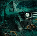 Bottom view to big offroad car wheel on country road and mountains backdrop. Jeep crashed into a puddle and picked up a Royalty Free Stock Photo