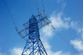 bottom view of the tower of power grids on blue sky background, High voltage, Electricity concept Royalty Free Stock Photo