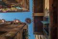 Bottom view of Traditional street lamp at an old Venetian house with green and colorful plants on the windows in the