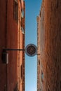 Bottom view of Traditional street lamp at an old Venetian house in the middle of the day with a blue sky