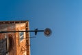 Bottom view of Traditional street lamp with a sitting dove bird looking to the camera at an old Venetian house in the